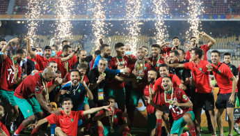 TOPSHOT - The Morocco team celebrates after winning the African Nations Championship (CHAN) final football match between Morocco and Mali at Stade Ahmadou Ahidjo in Yaounde, Cameroon, on February 7, 2021. (Photo by Daniel BELOUMOU OLOMO / AFP) (Photo by DANIEL BELOUMOU OLOMO/AFP via Getty Images)