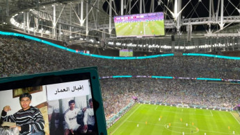 A picture of Iqbal, a Syrian detainee, is held up in front of a World Cup match in Doha. [Provided with permission by Families for Freedom].