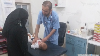 Doctor and woman with baby in a medical clinic