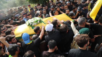 Mourners gather at a funeral for a Hezbollah member killed in an Israeli airstrike on 10 October. [William Christou - TNA]