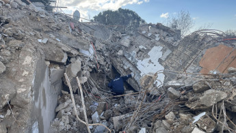 A man searches through the rubble of a house destroyed by an Israeli airstrike on 14 February in the southern Lebanese town of Souaneh. The strike killed a mother and her two children. [William Christou - TNA] 