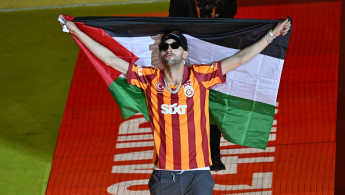  Hakim Ziyech of Galatasaray opens a Palestinian flag during Galatasaray's celebrations of Turkish Super Lig championship with team players at the RAMS Park in Istanbul, Turkiye on May 27, 2024.