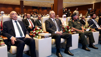 Libyan military strongman Khalifa Haftar (2nd L) and Aguila Saleh Issa, the speaker of Libya's eastern-based parliament (L), attend a conference for the country's development and reconstruction, in Libya's southern city of Sebha on September 5, 2024. 