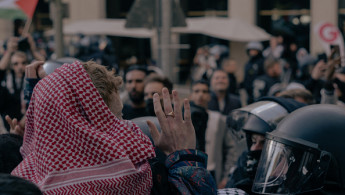 A man wearing a keffiyeh is pushed by German police at a demonstration in solidarity with Palestine in Berlin, Germany, on September 14, 2024.