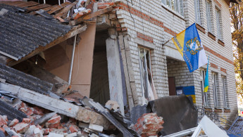  A flag with the coat of arms of the Kursk region is placed on a damaged building on September 10, 2024 in Sudzha, Kursk Region, Russia. 