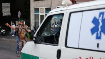  Lebanese army soldier gestures to an ambulance rushing wounded people to a hospital in Beirut on September 17, 2024, after explosions hit locations in several Hezbollah strongholds around Lebanon amid ongoing cross-border tensions between Israel and Hezbollah fighters. 