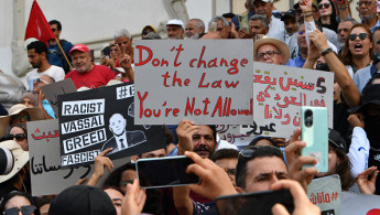 Tunisians chant slogans and wave placards during a demonstration against President Kais Seaid in the capital Tunis' Habib Bourguiba avenue on September 22, 2024, ahead of the upcoming Presidential Election. Photo by FETHI BELAID/AFP via Getty Images