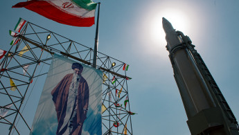 A big banner depicting Iran's Supreme Leader Ayatollah Ali Khamenei is placed next to a ballistic missile in Baharestan Square in Tehran, Iran, on September 26, 2024