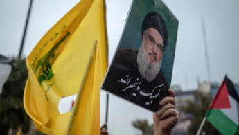 An Iranian protester holds up a portrait of Lebanon's Hezbollah Secretary General, Hassan Nasrallah, during a protest gathering to condemn an Israeli air strike against Hezbollah's headquarters in the suburb of Beirut, in Tehran, Iran, on September 28, 2024.