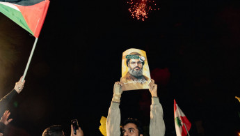 Demonstrators celebrate during a rally in Tehran after Iran fired a barrage of missiles into Israel