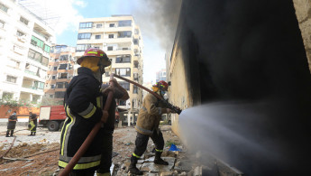 Firefighters work at the site of an overnight Israeli airstrike in Beirut's southern suburb of Shayyah on October 2, 2024.