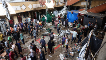 Palestinians react after an Israeli airstrike hit the Rafida school sheltering displaced people in Deir al-Balah in the central Gaza Strip on October 10, 2024. (Photo by EYAD BABA/AFP via Getty Images)