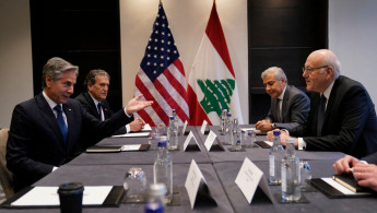 United States Secretary of State Antony Blinken (L) meets with Lebanon's Prime Minister Najib Mikati (R) in London