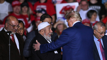 Former US President and Republican presidential candidate Donald Trump greets local leaders of the Muslim community