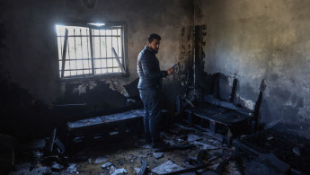 A Palestinian man inspects his damaged house following a reported attack earlier by Israeli settlers in Huwara town south of Nablus in the occupied West Bank on December 4, 2024. [Getty]