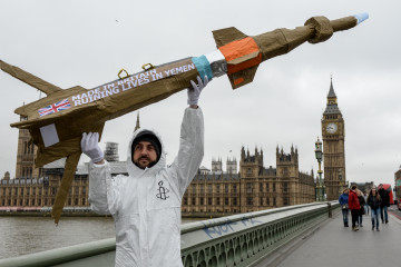 Activists march with homemade replica missiles past Parliament during a protest over UK arms sales to Saudi Arabia on 18 March, 2016. [Getty]