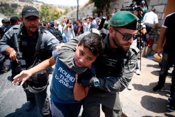 Israeli border guards detain a Palestinian youth during a demonstration outside the Lions Gate, a main entrance to Al-Aqsa mosque compound. [Getty]