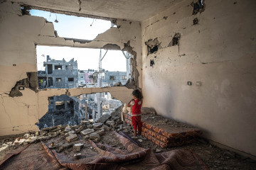 A Palestinian girl stands amid the rubble of her destroyed home on 24 May 2021 in Beit Hanoun, Gaza. [Getty]