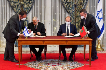 Director General of Israel's Population and Immigration Agency Shlomo Mor-Yosef (L) and Minister Delegate to Morocco's Minister for Foreign Affairs Mohcine Jazouli sign an agreement at the Royal Palace in the Moroccan capital Rabat. [Getty]