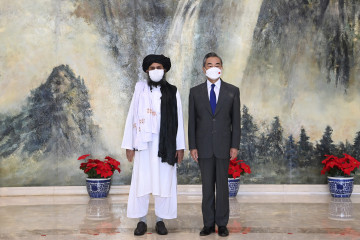 Taliban co-founder Mullah Abdul Ghani Baradar, left, and Chinese Foreign Minister Wang Yi pose for a photo during their meeting in Tianjin, China, Wednesday, July 28, 2021. [Li Ran/Xinhua via AP]