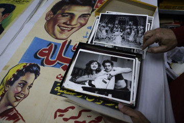 Abboudi Abu Jawdeh shows part of his vintage cinema poster collection at his office in the Lebanese capital Beirut [Getty Images]