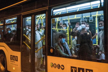 Afghan refugees are seen onboard a bus upon arrival at Skopje International Airport, after being evacuated from Kabul following the Taliban takeover of Afghanistan [Getty Images]