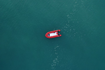 An empty migrant dinghy floats off the beach at St Margaret's Bay after the occupants landed from France on in September 2020 in Dover, England. [Getty]