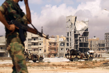 Members of the self-styled Libyan National Army, loyal to the country's east strongman Khalifa Haftar, patrol a street in central Benghazi on 6 July 2017. [Getty]