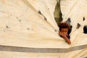 A Yemeni child who fled fighting between Yemen's armed rebels and pro-government forces in Hodeida, is pictured at a makeshift camp in the district of Abs, in Yemen's northwestern Hajjah province on 13 May 2019. [Getty]