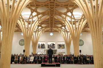 Turkish President Recep Tayyip Erdogan makes a speech as he and his wife Emine Erdogan (not seen) attend official opening ceremony of Cambridge Central Mosque in London [Getty Images]