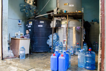 A young boy seen selling clean water in a shop. Lebanon host over a million of refugees that had fled from the neighbouring country seeking safety [Getty Images]