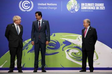 British Prime Minister Boris Johnson (L) and UN Secretary-General Antonio Guterres (R) greet Emir of Qatar Sheikh Tamim bin Hamad Al Thani as they arrive for day two of COP26 at SECC on November 1, 2021