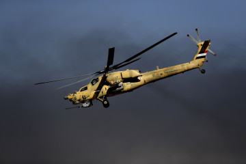 An Iraqi airforce MI-28 helicopter flies near the army base of Qaryat Jaddalat, south of the city of Mosul on November 25, 2016, during a massive operation to oust IS jihadists from the country's second city.