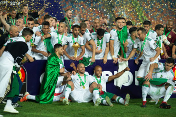  Algeria captain Riyad Mahrez lifts the trophy as his team celebrate winning the 2019 Africa Cup of Nations Final between Senegal and Algeria