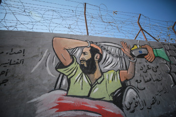 A painting wall shows Palestinian prisoner in Israeli jail Maher Al-Akhras, who has been on a hunger strike for 84 days, rejecting the food, at Nuseirat Refugee Camp in Gaza City, Gaza on October 18, 2020. [Getty]