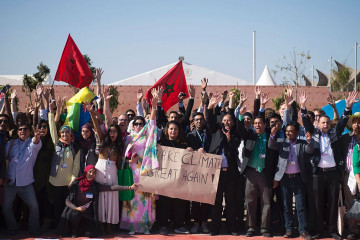 Members of International delegations pose for a group photo outside the COP22 climate conference on November 18, 2016