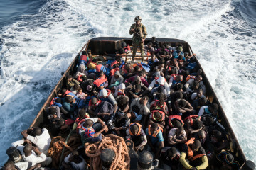 A Libyan coast guardsman stands on a boat during the rescue of 147 illegal immigrants attempting to reach Europe off the coastal town of Zawiyah, 45 kilometres west of the capital Tripoli, on June 27, 2017.