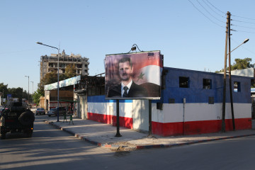 A poster with an image of Syria's President Bashar al-Assad in a street. Marina Lystseva/TASS (Photo by Marina Lystseva\TASS via Getty Images)