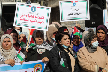 Palestinian women take part in an event supporting the women prisoners in the Israeli jails on the day before international women's day in front of the ICRC office in Gaza City