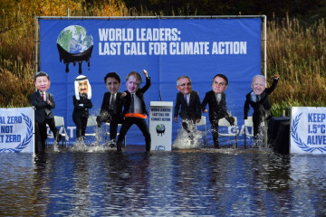 limate change activists dressed as world leaders, including from left, Japan's Prime Minister Fumio Kishida, Saudi Arabia's King Salman bin Abdulaziz, Canada's Prime Minister Justin Trudeau, Britain's Prime Minister Boris Johnson, Australia's Prime Minister Scott Morrison, Brazil's President Jair Bolsonaro, and US President Joe Biden, pose for a photograph during a demonstration in the Forth and Clyde Canal in Glasgow 