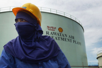 A Worker is pictured at oil and gas processing facilities at Seria, September 7, 2004 in Brunei. Brunei produces around 218,000 barrels a day of crude oil and natural gas liquids and is a the major income of the South East Asian Sultanate