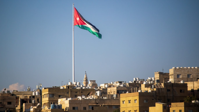 The Jordanian flag flies over the hills of Amman