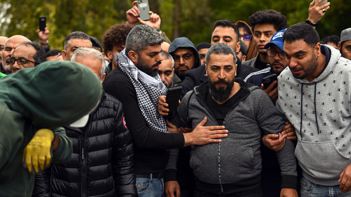  Oday Al-Fayoumi (center in gray hoodie) watches as his 6-year-old Palestinian American Wadea Al-Fayoumi is buried at Parkholm Cemetery on Monday, October 16, 2023 in LaGrange, Illinois.