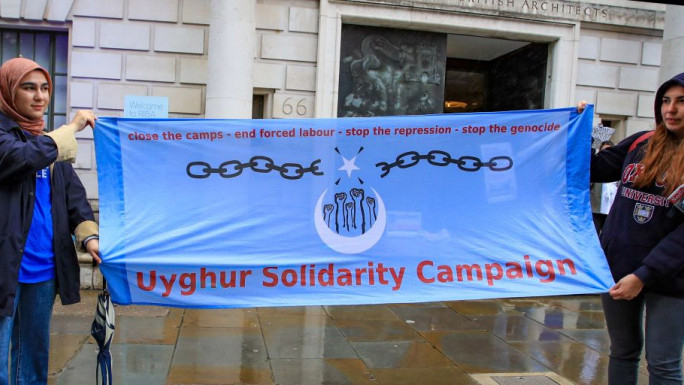 People gather outside the Chinese Embassy in central London during a demonstration in support of Uighur people over ongoing human rights violations in China's Xinjiang