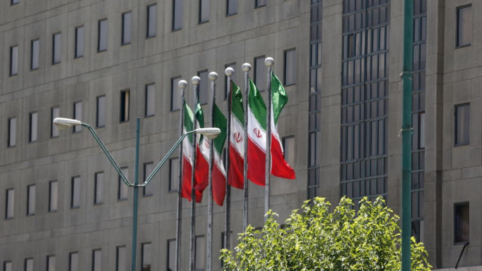 Six Iranian flags outside Tehran's parliament