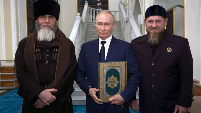 Putin was presented with a copy of the Quran while visiting a mosque in Grozny with Chechen leader Kadyrov (right) [Getty]