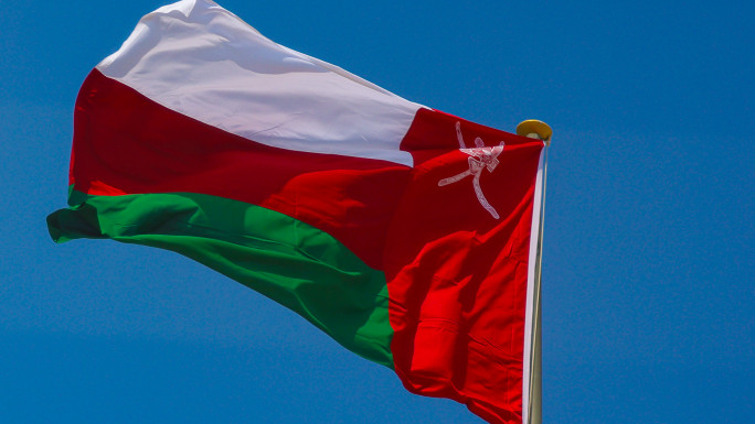 Oman National Flag Waving Against Clear Blue Sky [Getty]