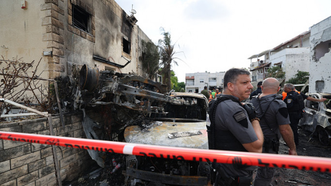 First responders and Israeli security forces gather amid debris and charred vehicles in Kiryat Bialik in the Haifa district of Israel, following a reported strike by Lebanon's Hezbollah on September 22, 2024. (Photo by JACK GUEZ/AFP via Getty Images)