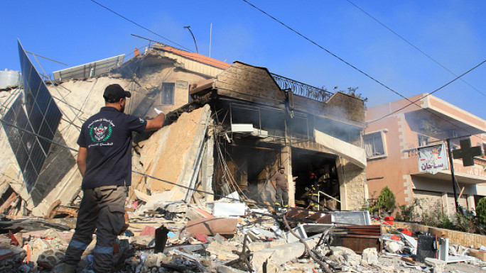 A rescuer inspects the debris at the site of an overnight Israeli strike on a pharmacy in the southern Lebanese village of Akbiyeh on September 24, 2024. (Photo by MAHMOUD ZAYYAT/AFP via Getty Images)