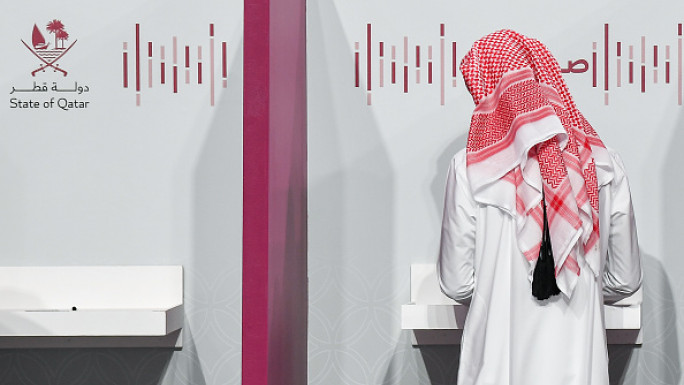 A Qatari man casts his ballot at a polling station in a general referendum on constitutional amendments on November 5, 2024. (Photo by Noushad Thekkayil/NurPhoto via Getty Images)